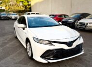 2018 Toyota Camry Ascent Hybrid Sedan in White.