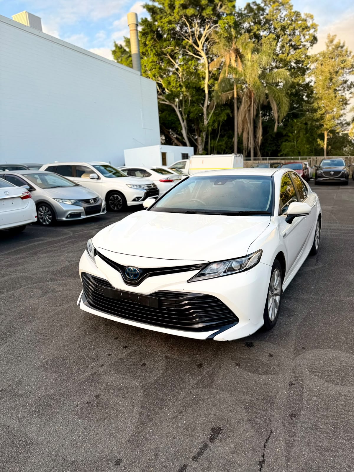 2018 Toyota Camry Ascent Hybrid Sedan in White.
