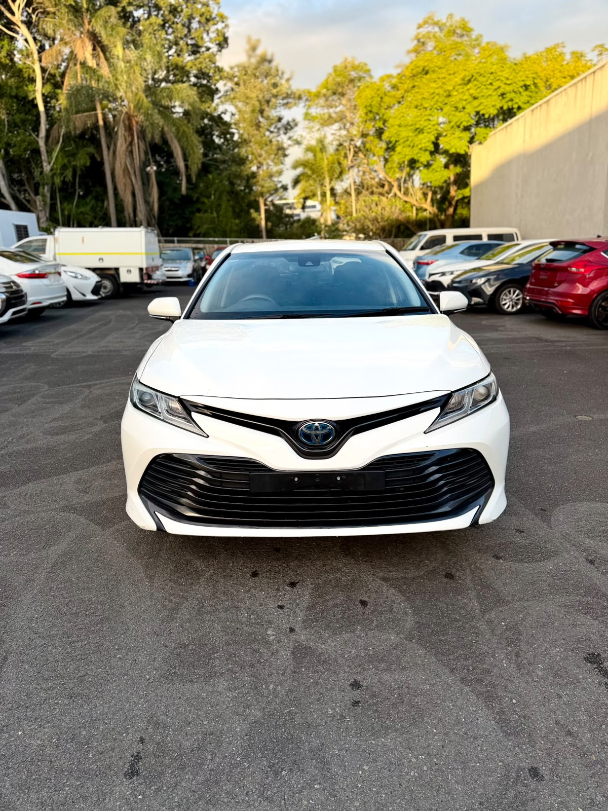 2018 Toyota Camry Ascent Hybrid Sedan in White.