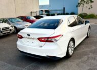 2018 Toyota Camry Ascent Hybrid Sedan in White.