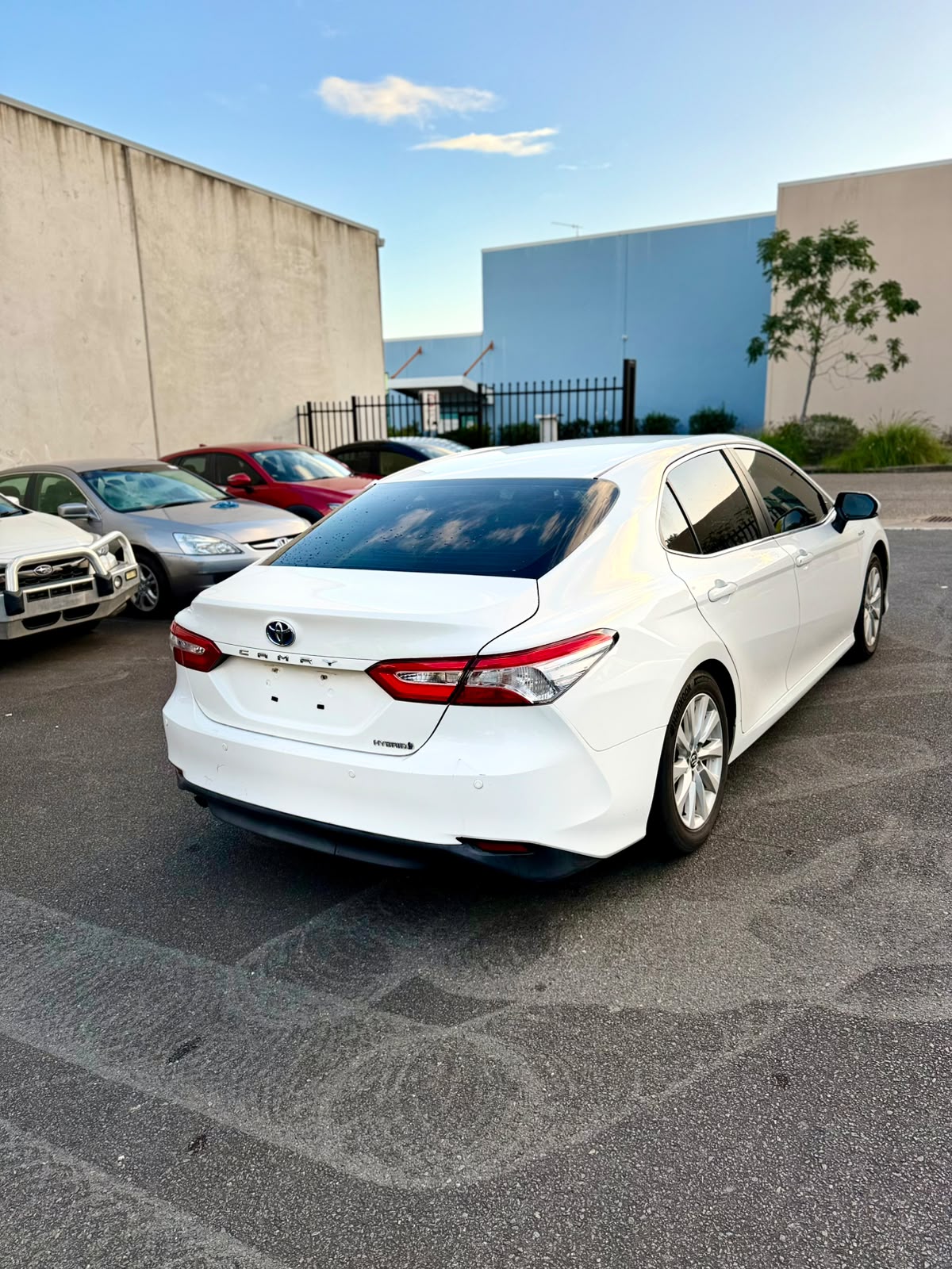 2018 Toyota Camry Ascent Hybrid Sedan in White.