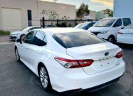 2018 Toyota Camry Ascent Hybrid Sedan in White.