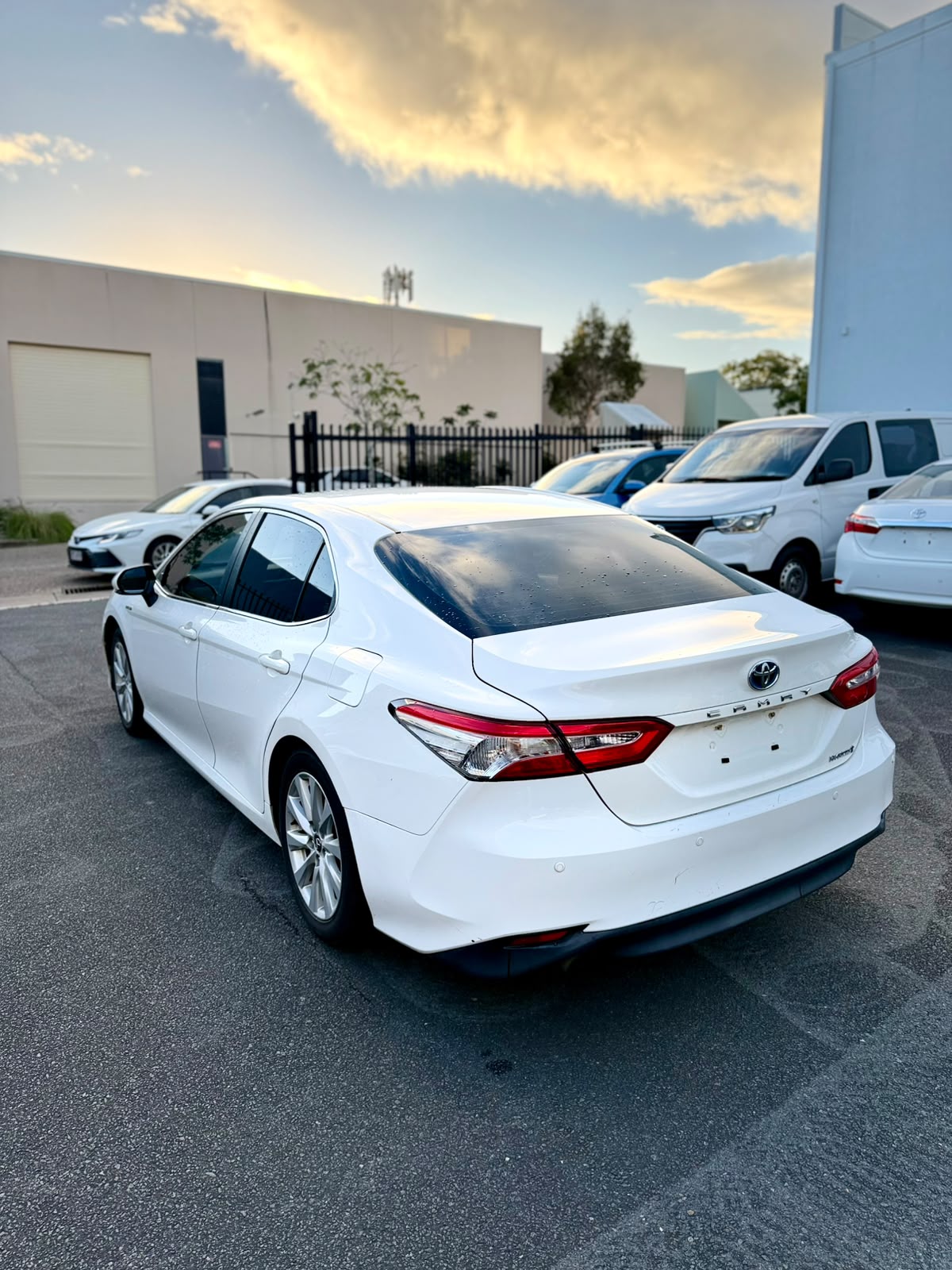 2018 Toyota Camry Ascent Hybrid Sedan in White.