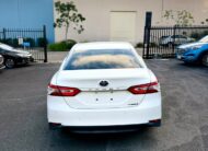2018 Toyota Camry Ascent Hybrid Sedan in White.