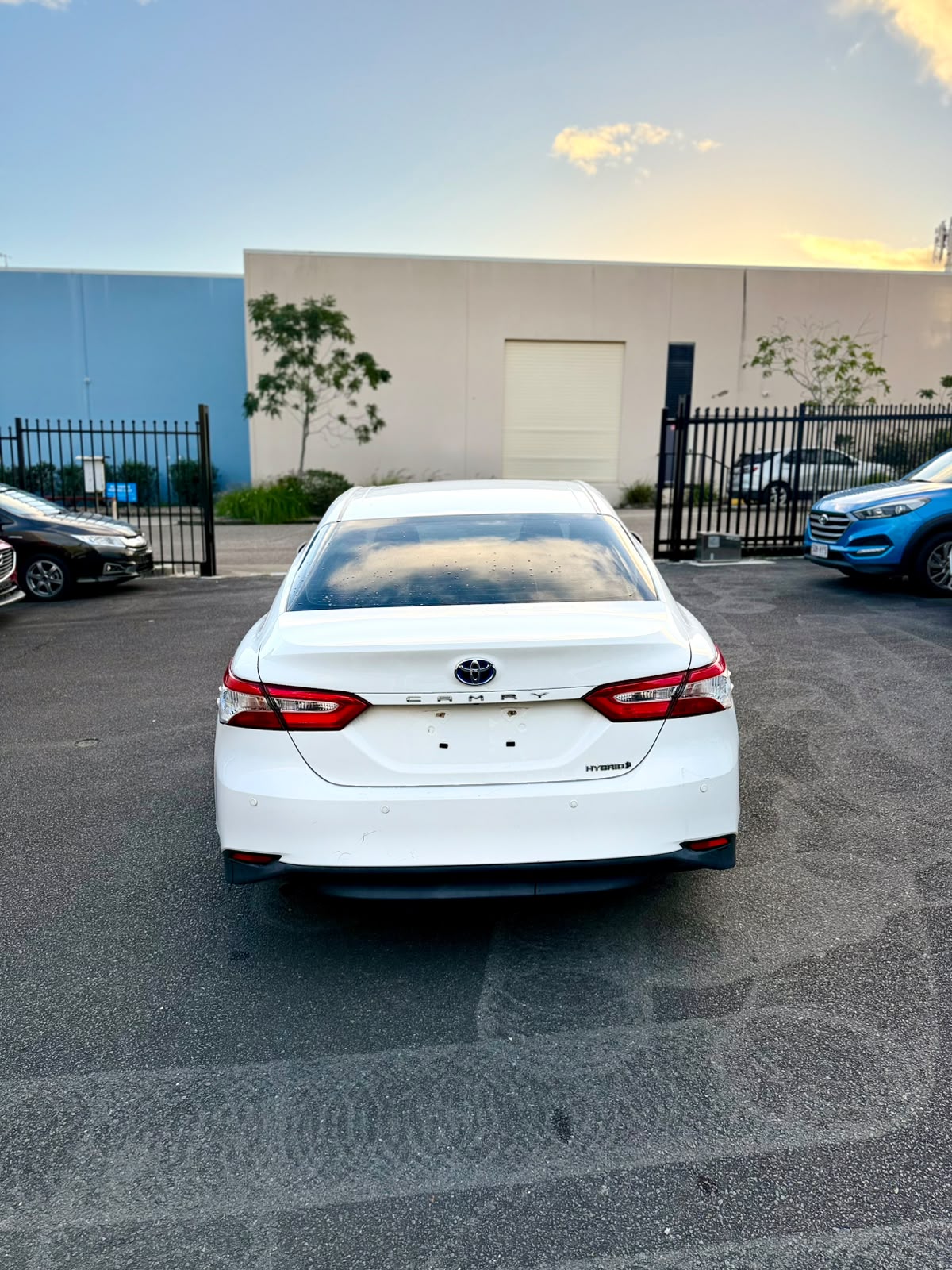 2018 Toyota Camry Ascent Hybrid Sedan in White.