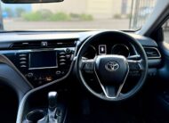 2018 Toyota Camry Ascent Hybrid Sedan in White.