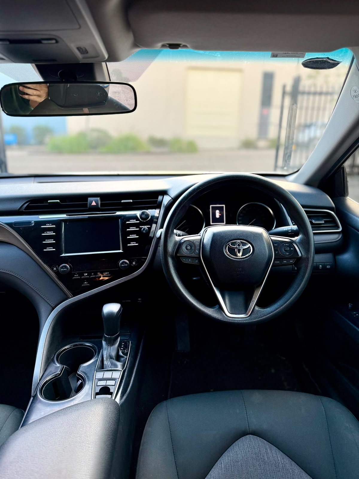 2018 Toyota Camry Ascent Hybrid Sedan in White.