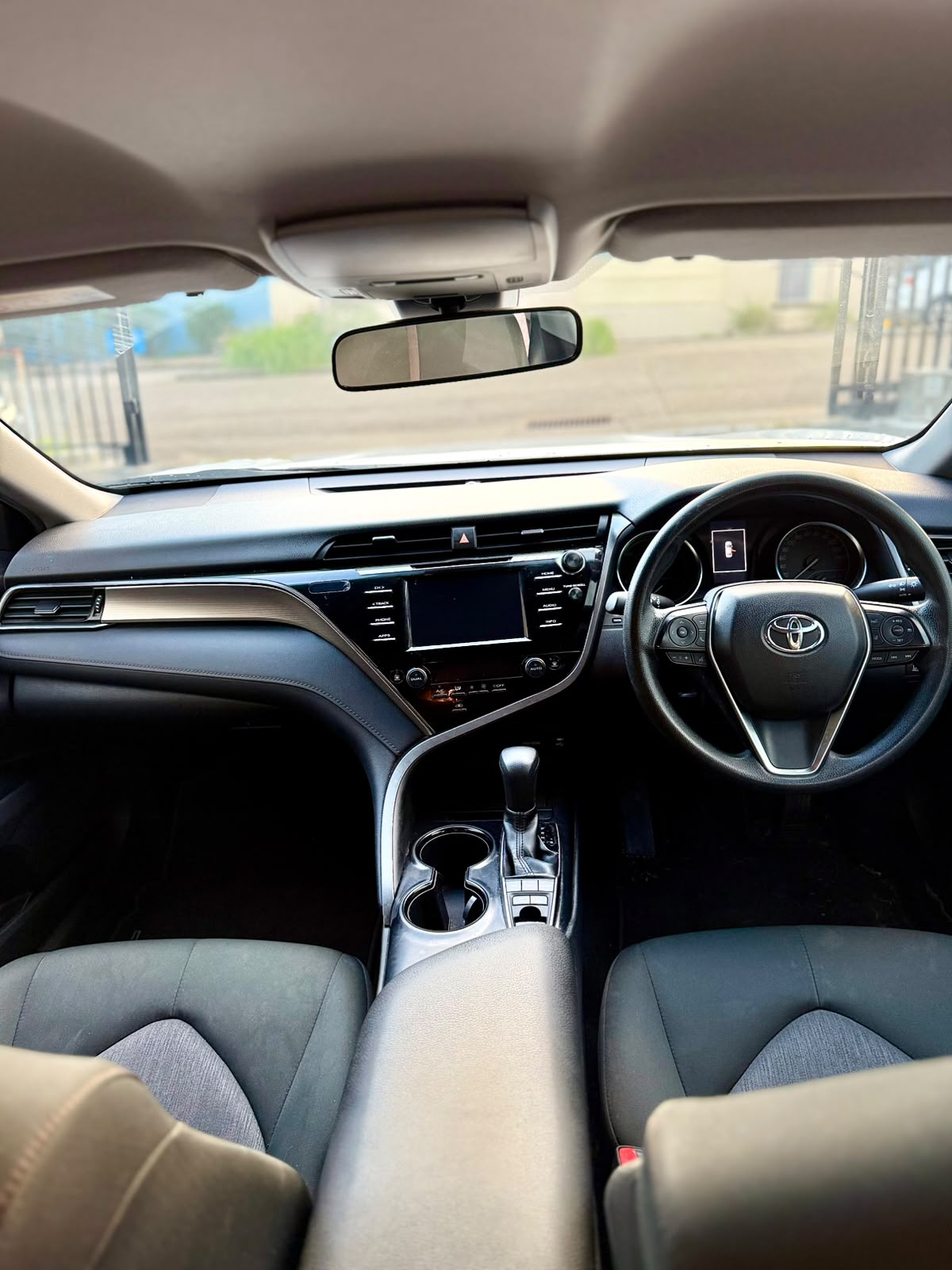 2018 Toyota Camry Ascent Hybrid Sedan in White.