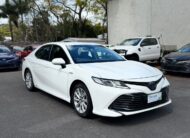 2019 Toyota Camry Ascent Hybrid Sedan in White.