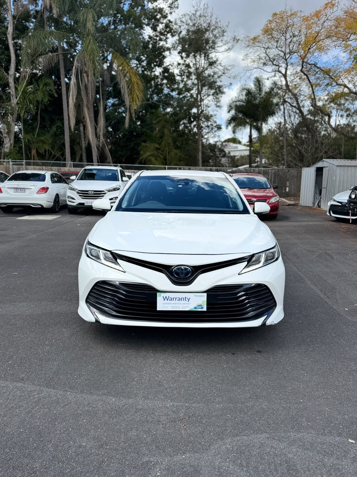 2019 Toyota Camry Ascent Hybrid Sedan in White.