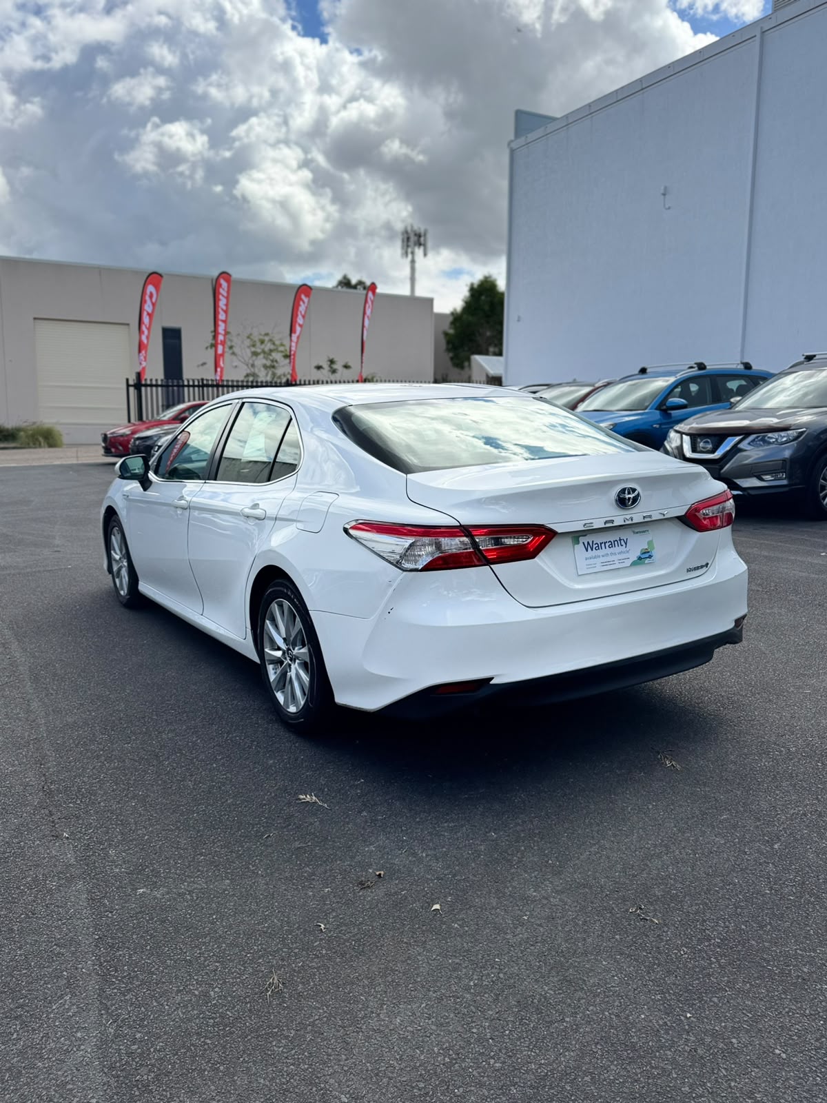 2019 Toyota Camry Ascent Hybrid Sedan in White.