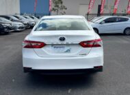 2019 Toyota Camry Ascent Hybrid Sedan in White.