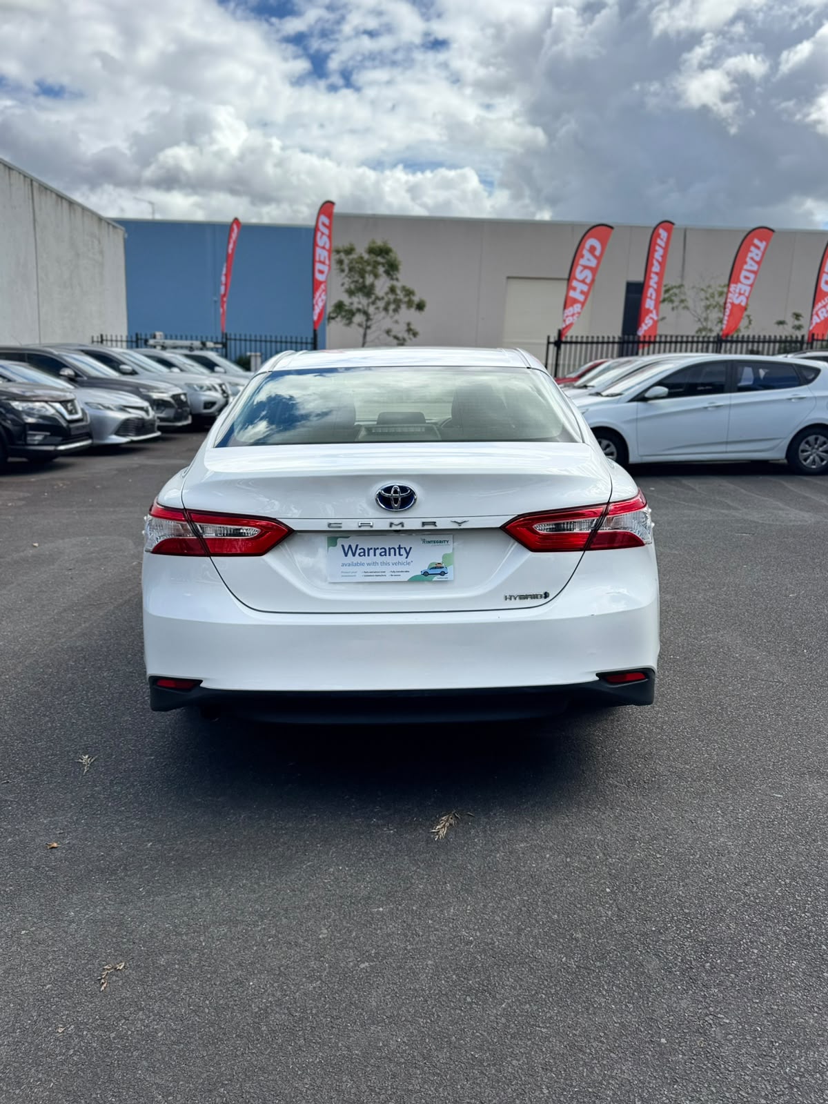2019 Toyota Camry Ascent Hybrid Sedan in White.