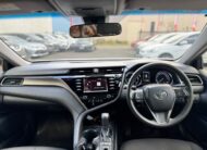 2019 Toyota Camry Ascent Hybrid Sedan in White.