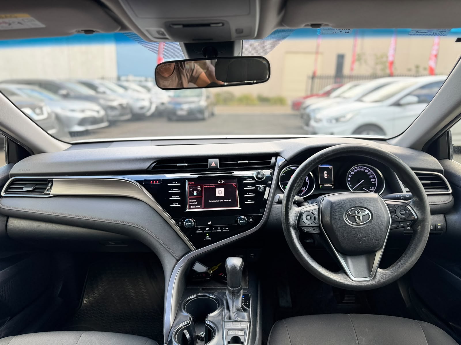 2019 Toyota Camry Ascent Hybrid Sedan in White.