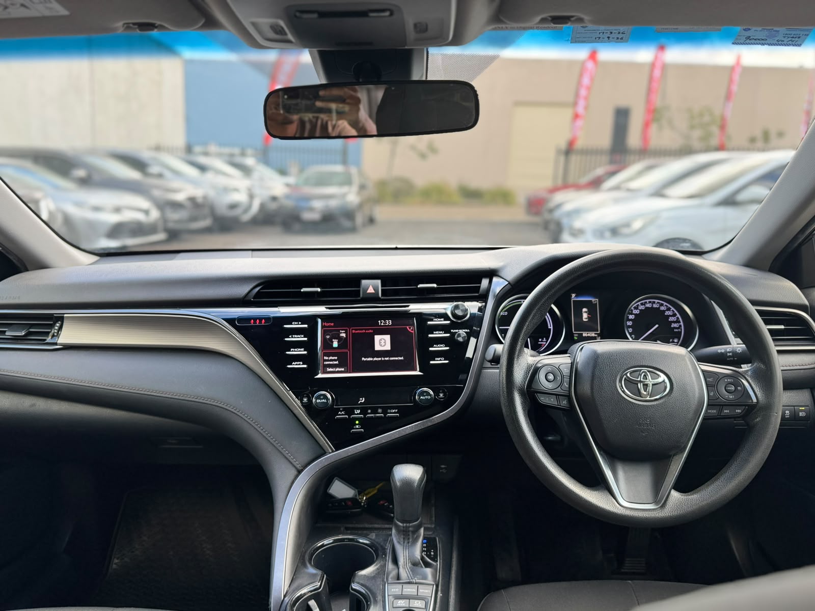 2019 Toyota Camry Ascent Hybrid Sedan in White.