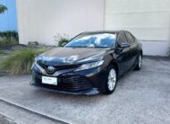 2020 Toyota Camry Ascent Hybrid Sedan in Brown.