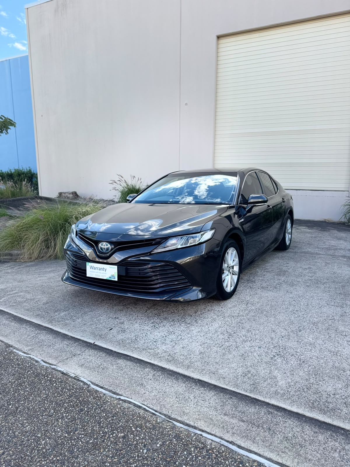 2020 Toyota Camry Ascent Hybrid Sedan in Brown.