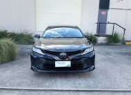 2020 Toyota Camry Ascent Hybrid Sedan in Brown.