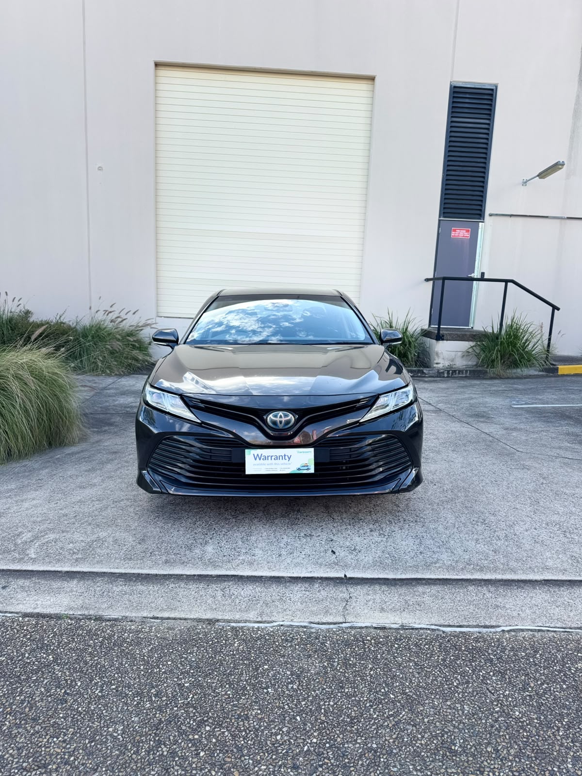 2020 Toyota Camry Ascent Hybrid Sedan in Brown.