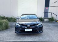 2020 Toyota Camry Ascent Hybrid Sedan in Brown.