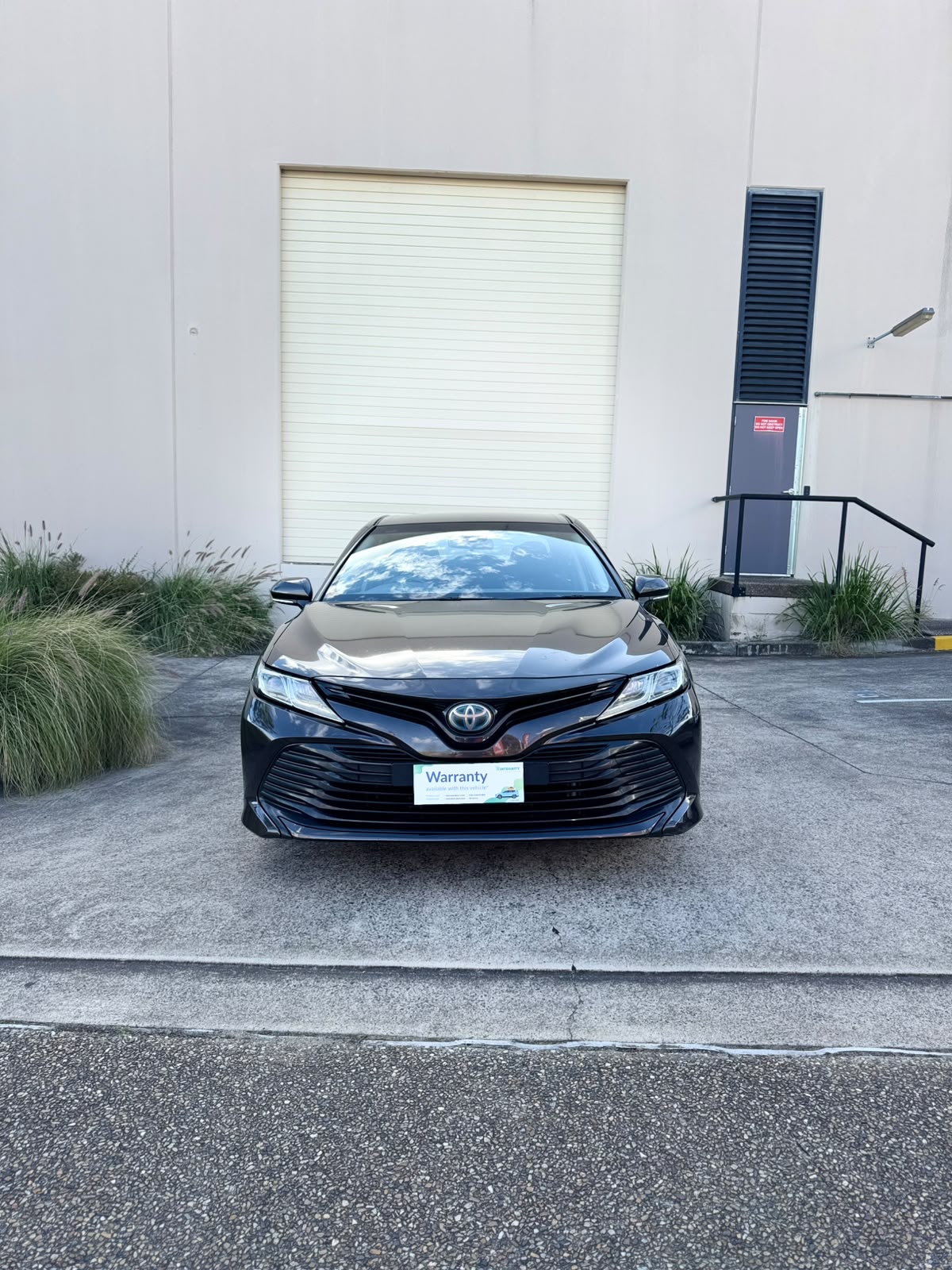 2020 Toyota Camry Ascent Hybrid Sedan in Brown.