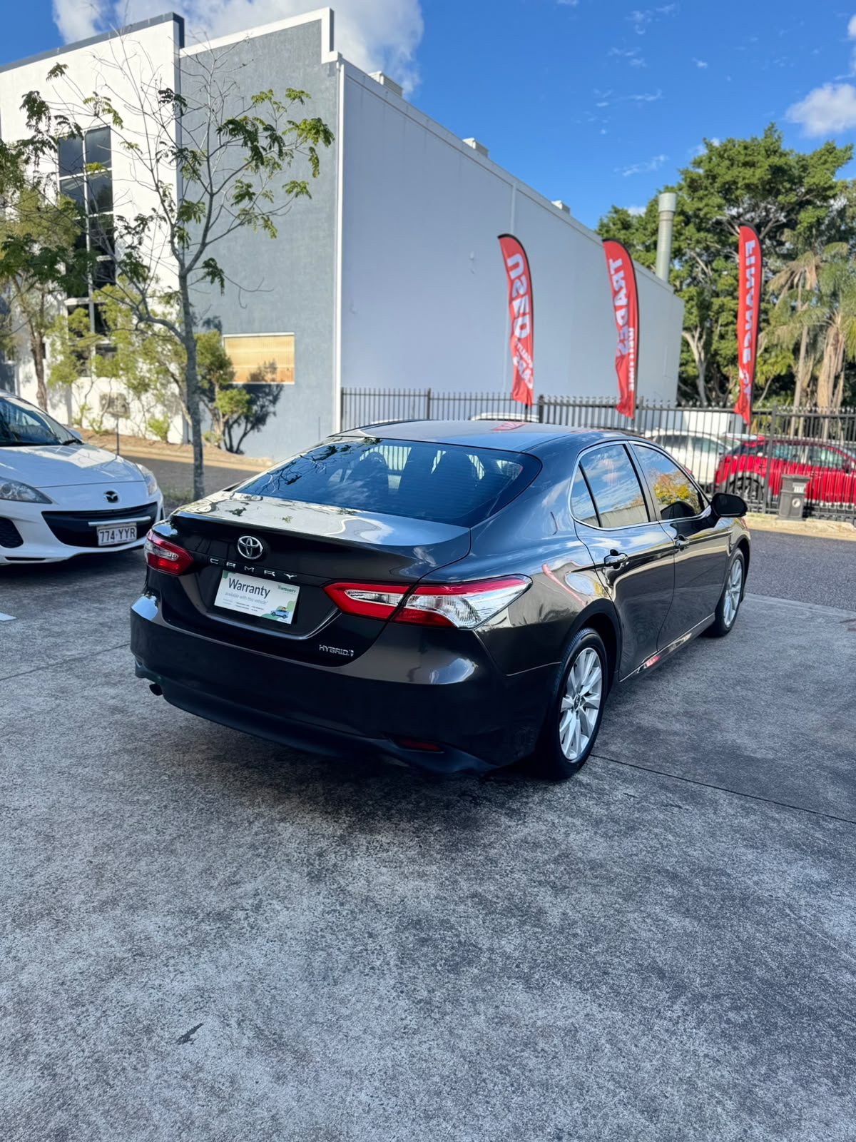 2020 Toyota Camry Ascent Hybrid Sedan in Brown.