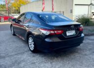 2020 Toyota Camry Ascent Hybrid Sedan in Brown.