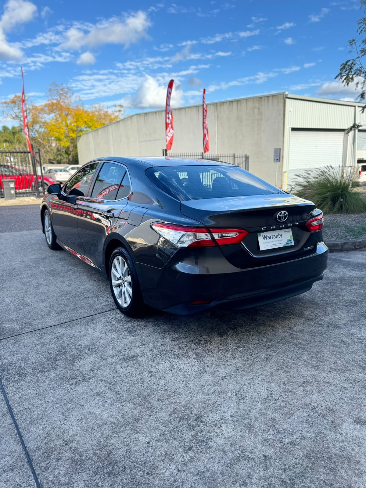 2020 Toyota Camry Ascent Hybrid Sedan in Brown.