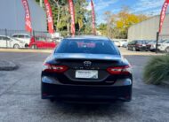 2020 Toyota Camry Ascent Hybrid Sedan in Brown.
