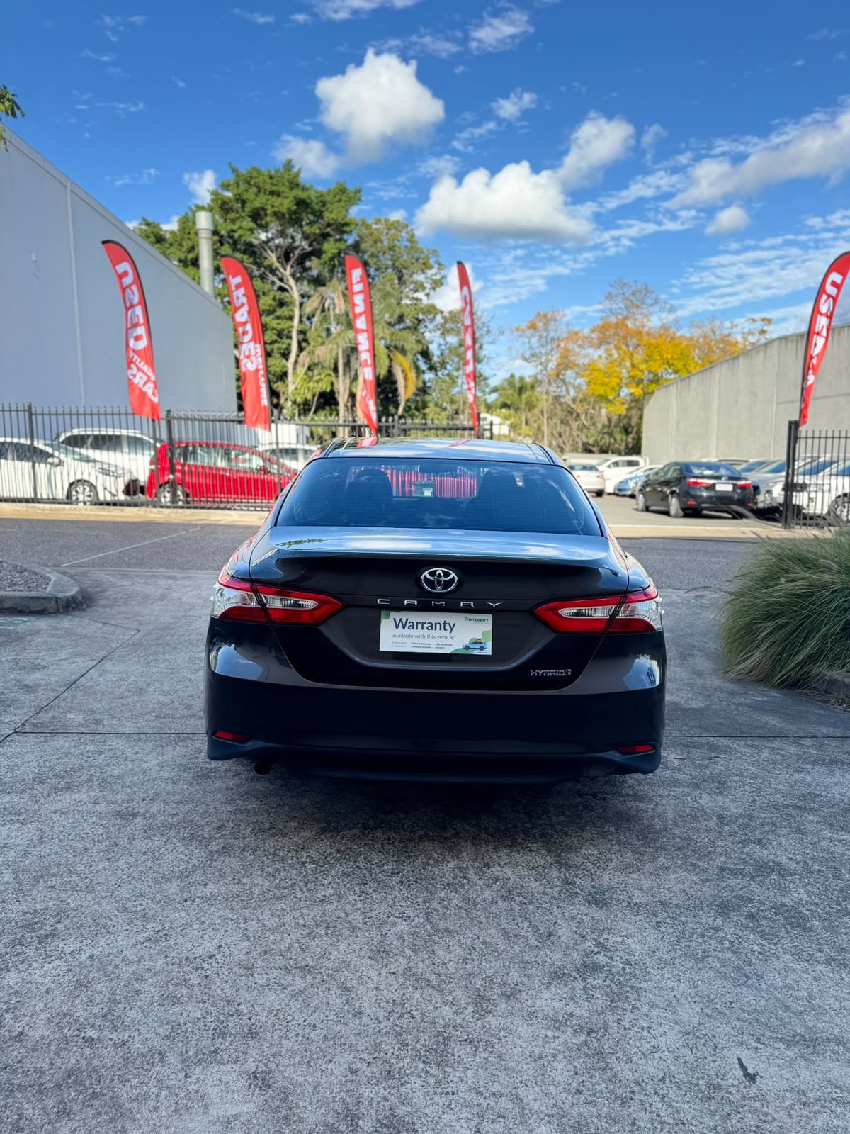 2020 Toyota Camry Ascent Hybrid Sedan in Brown.