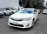 2013 Toyota Camry Hybrid HL Sedan in White.