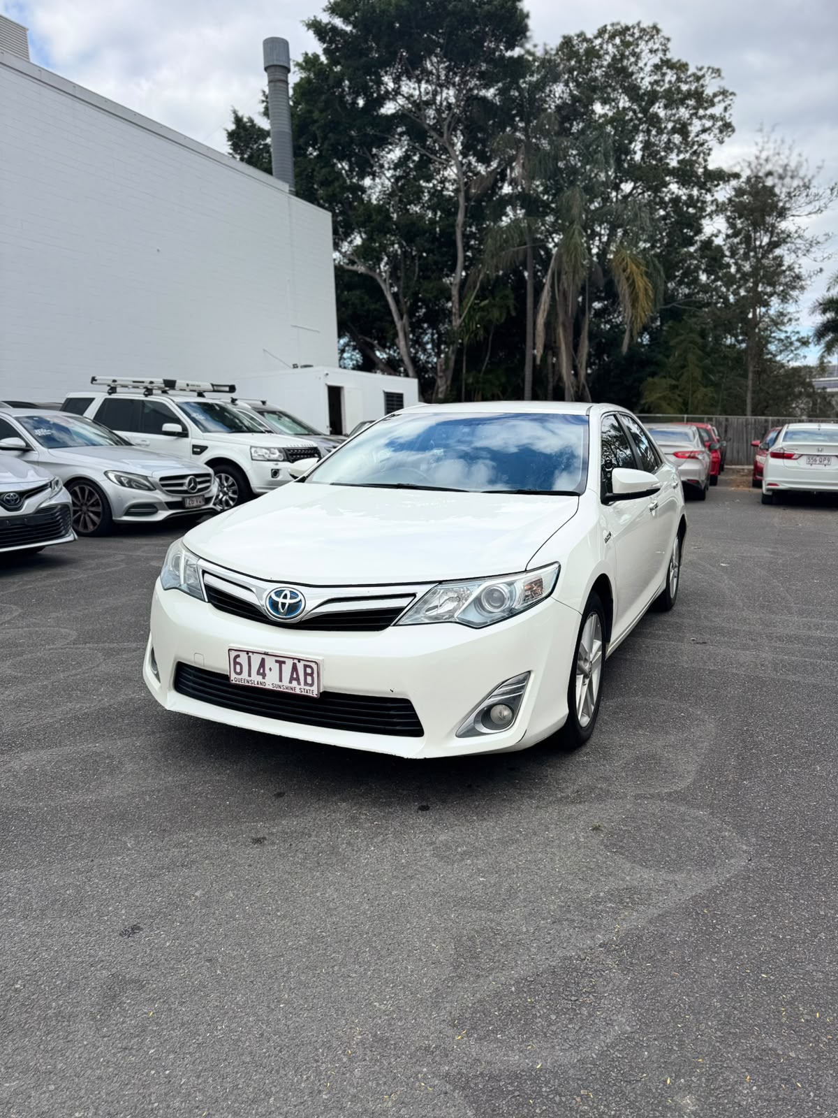 2013 Toyota Camry Hybrid HL Sedan in White.