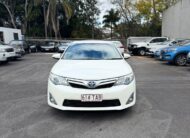 2013 Toyota Camry Hybrid HL Sedan in White.