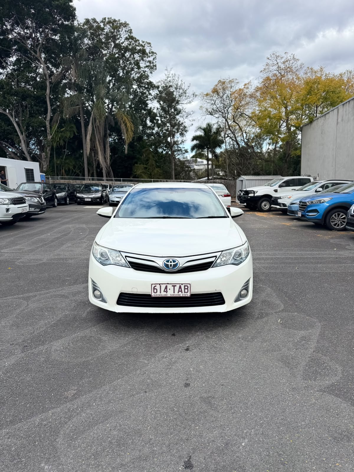 2013 Toyota Camry Hybrid HL Sedan in White.