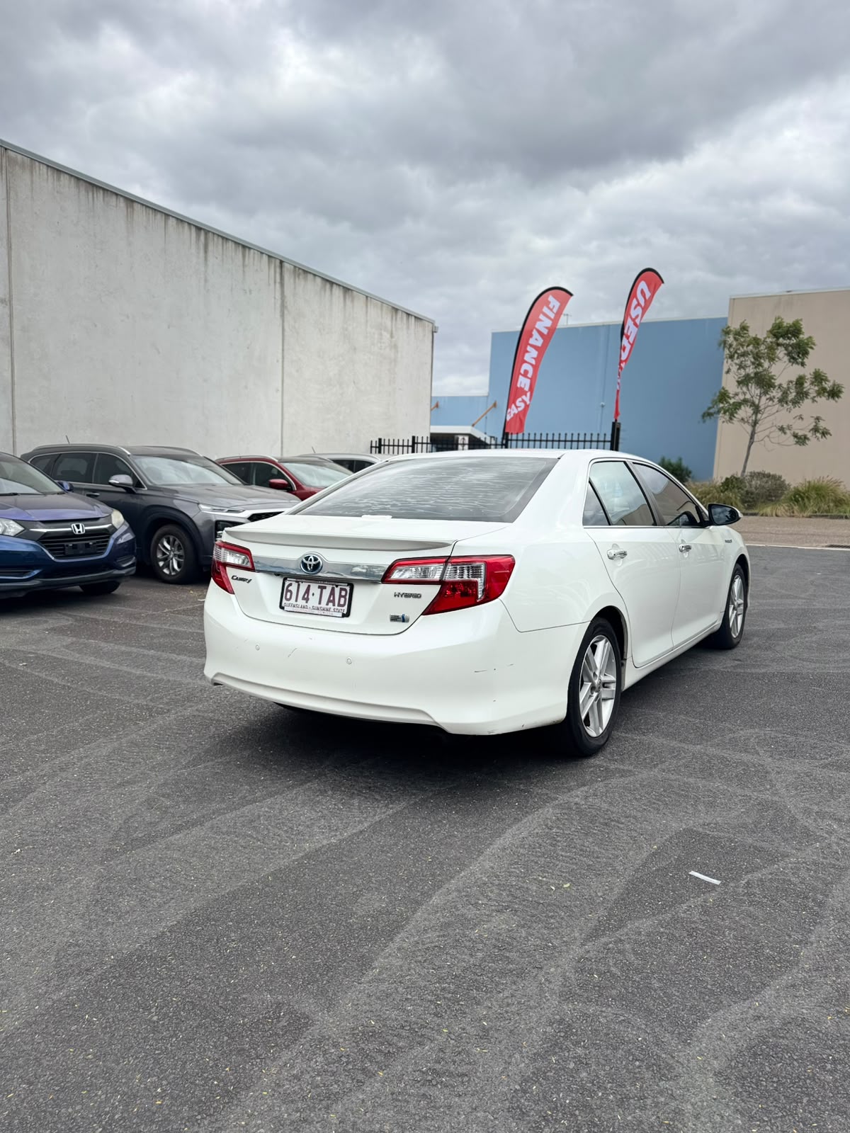 2013 Toyota Camry Hybrid HL Sedan in White.