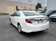 2013 Toyota Camry Hybrid HL Sedan in White.