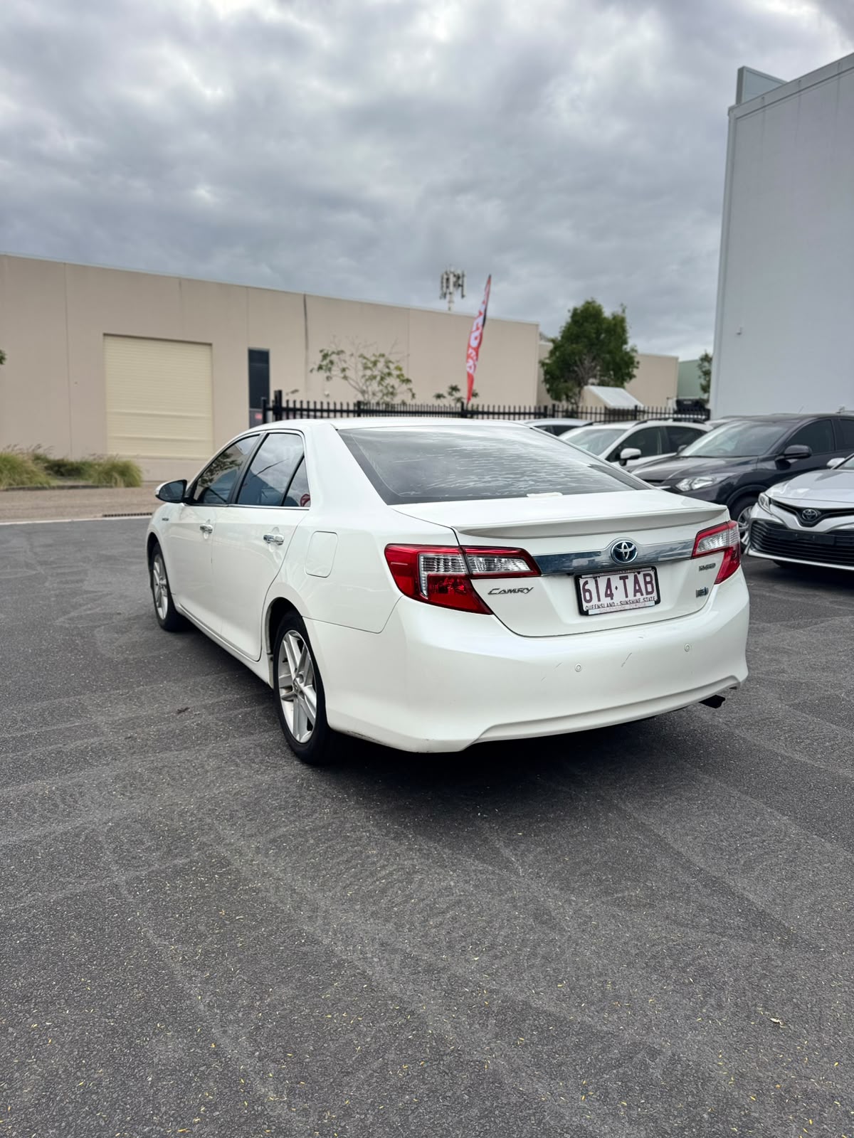 2013 Toyota Camry Hybrid HL Sedan in White.