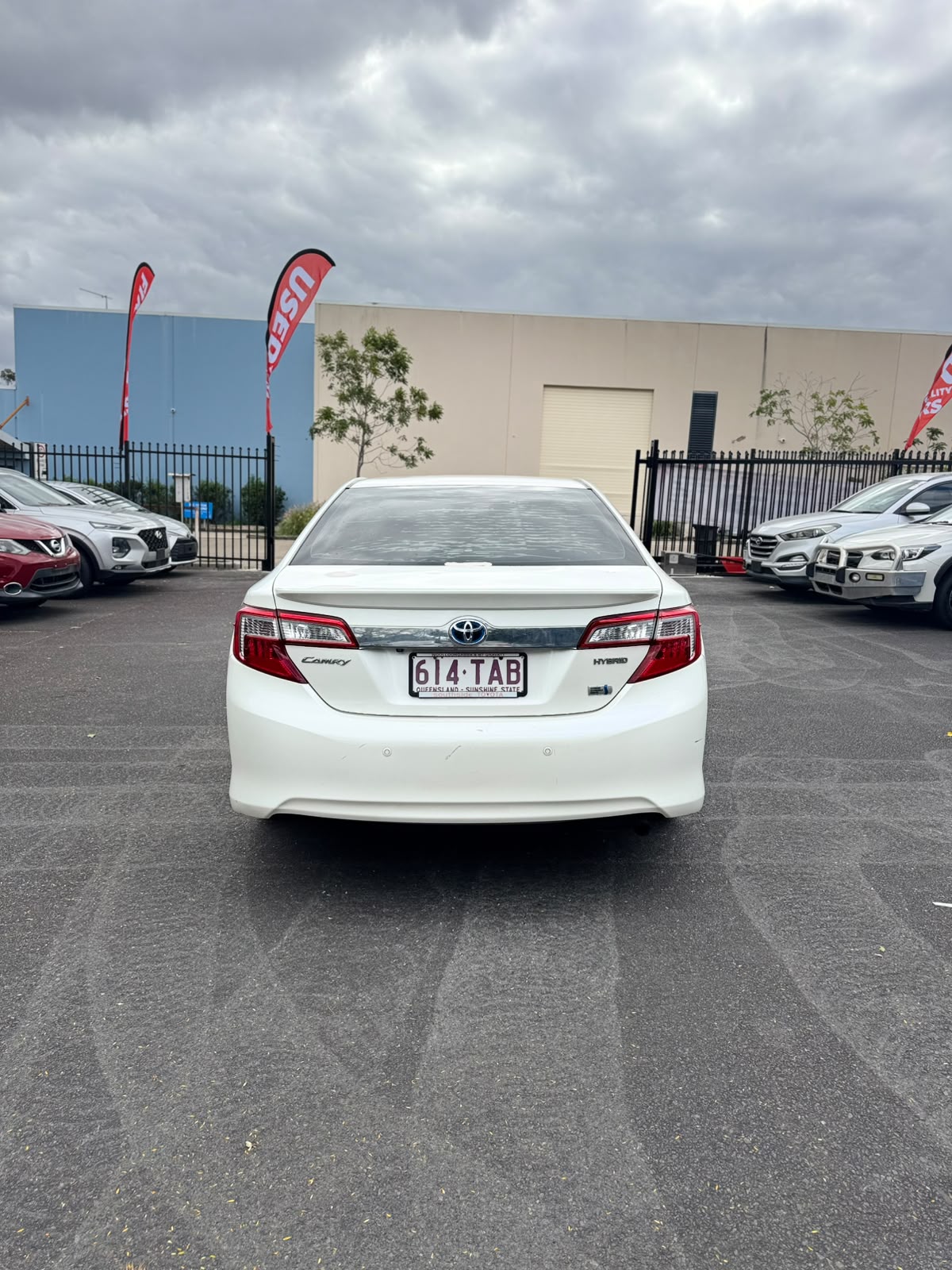 2013 Toyota Camry Hybrid HL Sedan in White.