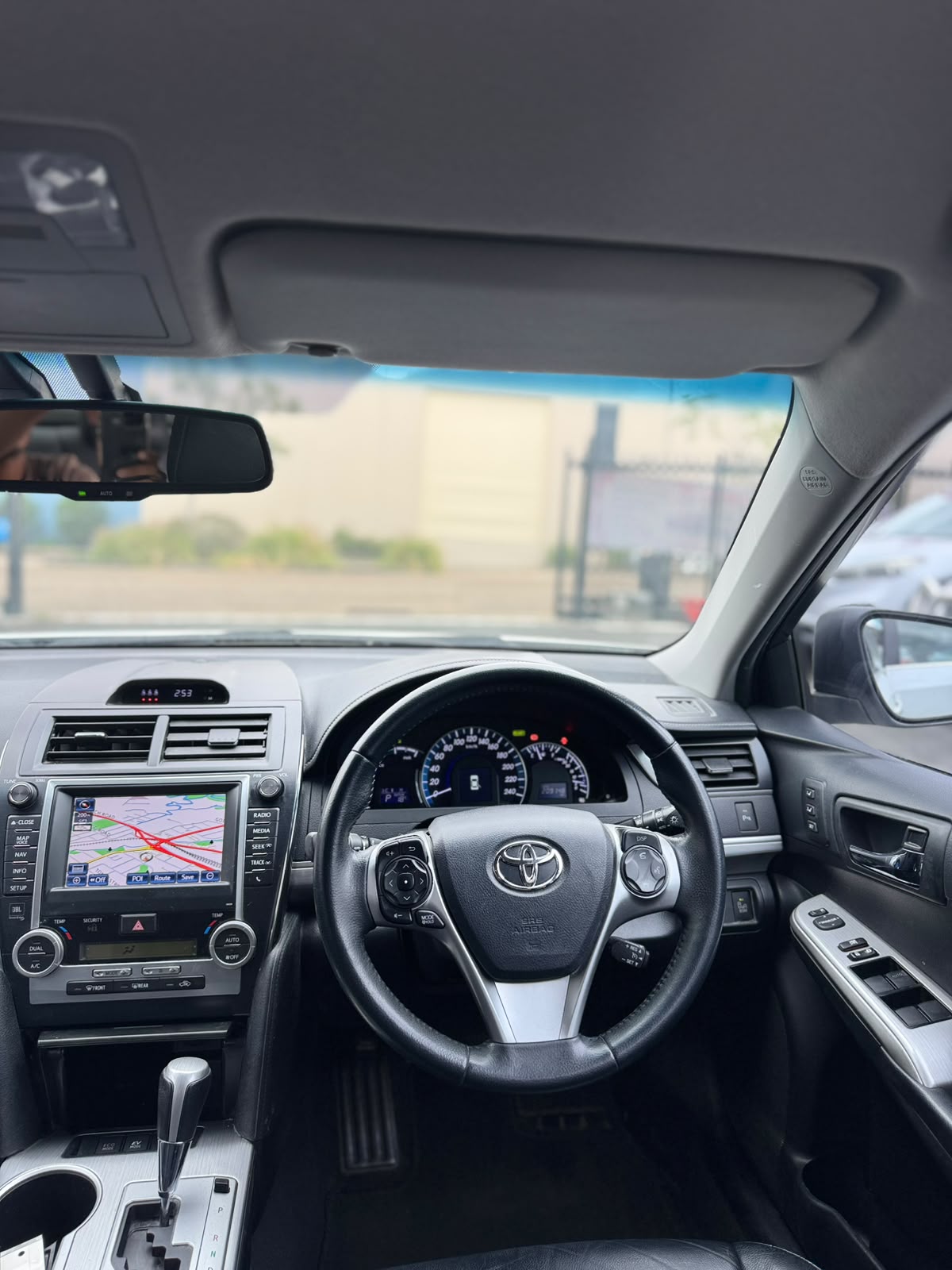 2013 Toyota Camry Hybrid HL Sedan in White.