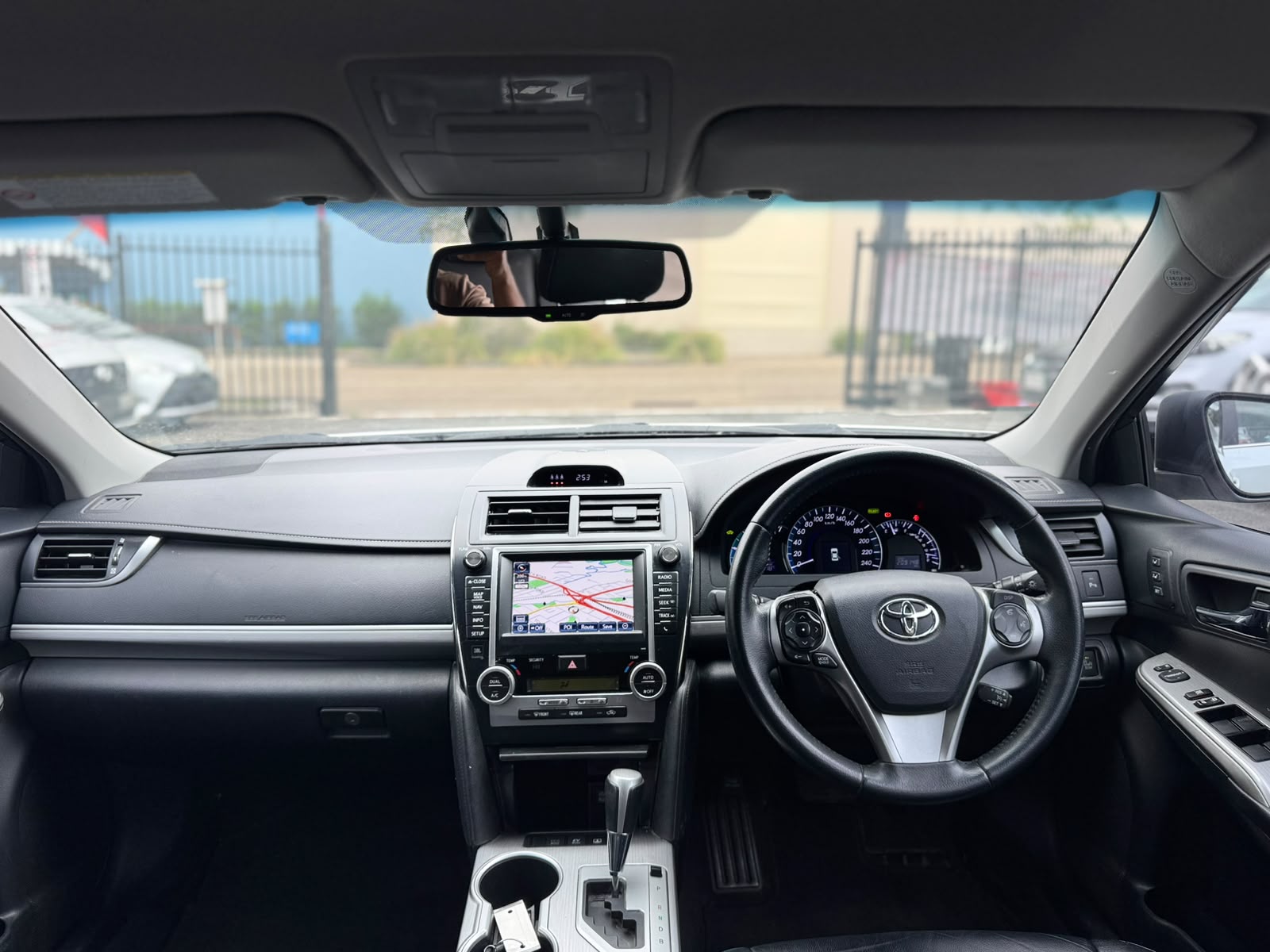 2013 Toyota Camry Hybrid HL Sedan in White.
