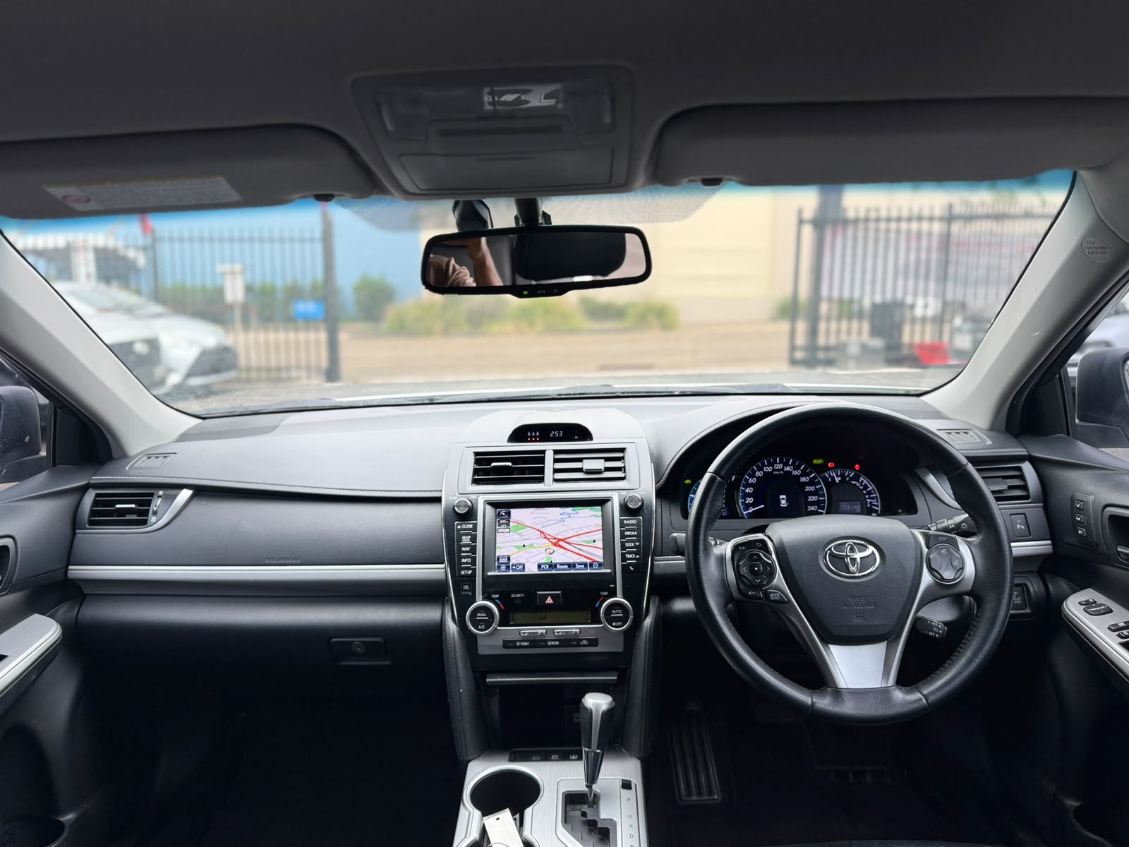 2013 Toyota Camry Hybrid HL Sedan in White.