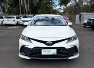 2021 Toyota Camry Hybrid Ascent Sedan in White.