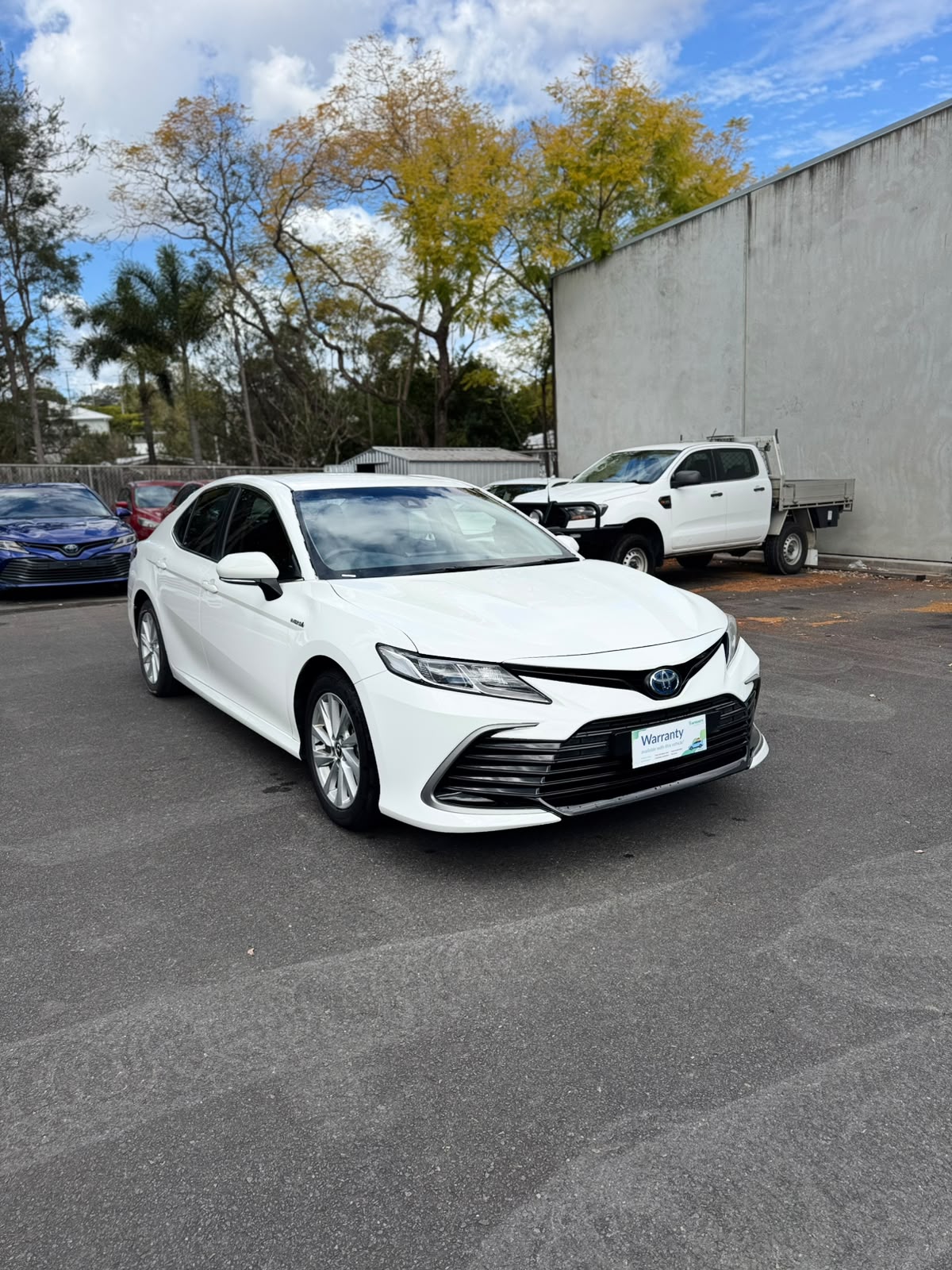 2021 Toyota Camry Hybrid Ascent Sedan in White.