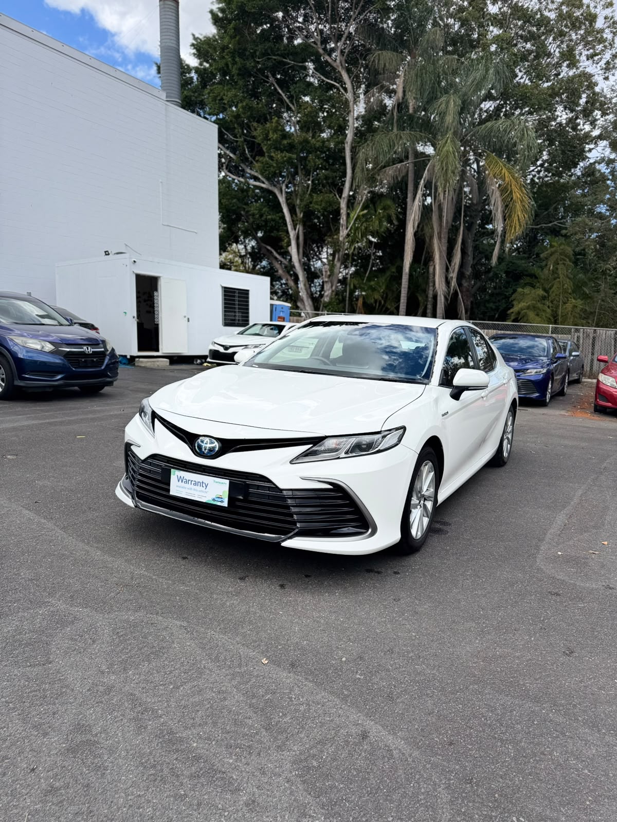 2021 Toyota Camry Hybrid Ascent Sedan in White.