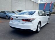 2021 Toyota Camry Hybrid Ascent Sedan in White.