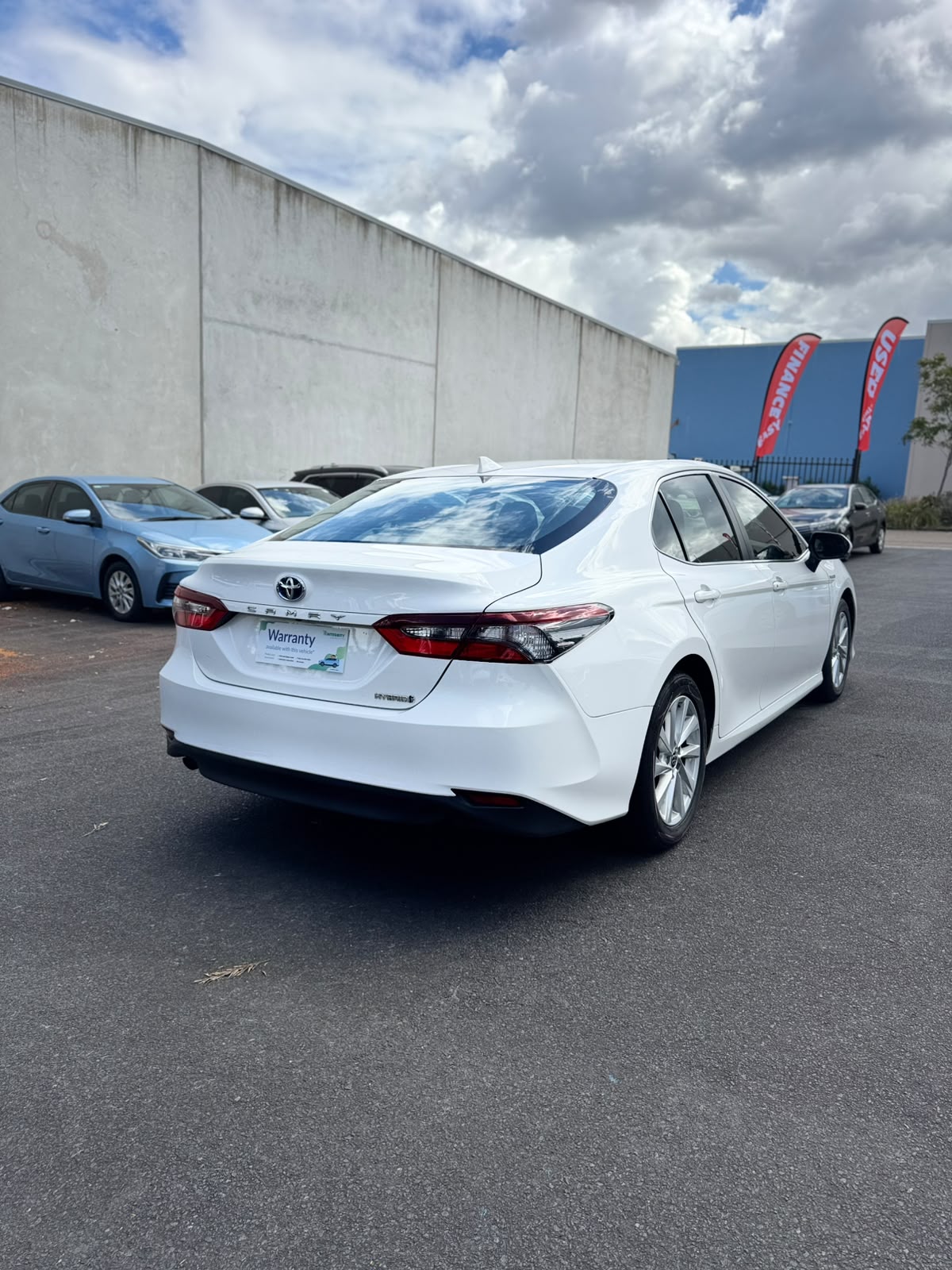 2021 Toyota Camry Hybrid Ascent Sedan in White.