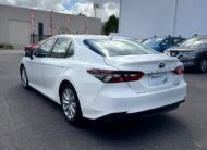 2021 Toyota Camry Hybrid Ascent Sedan in White.
