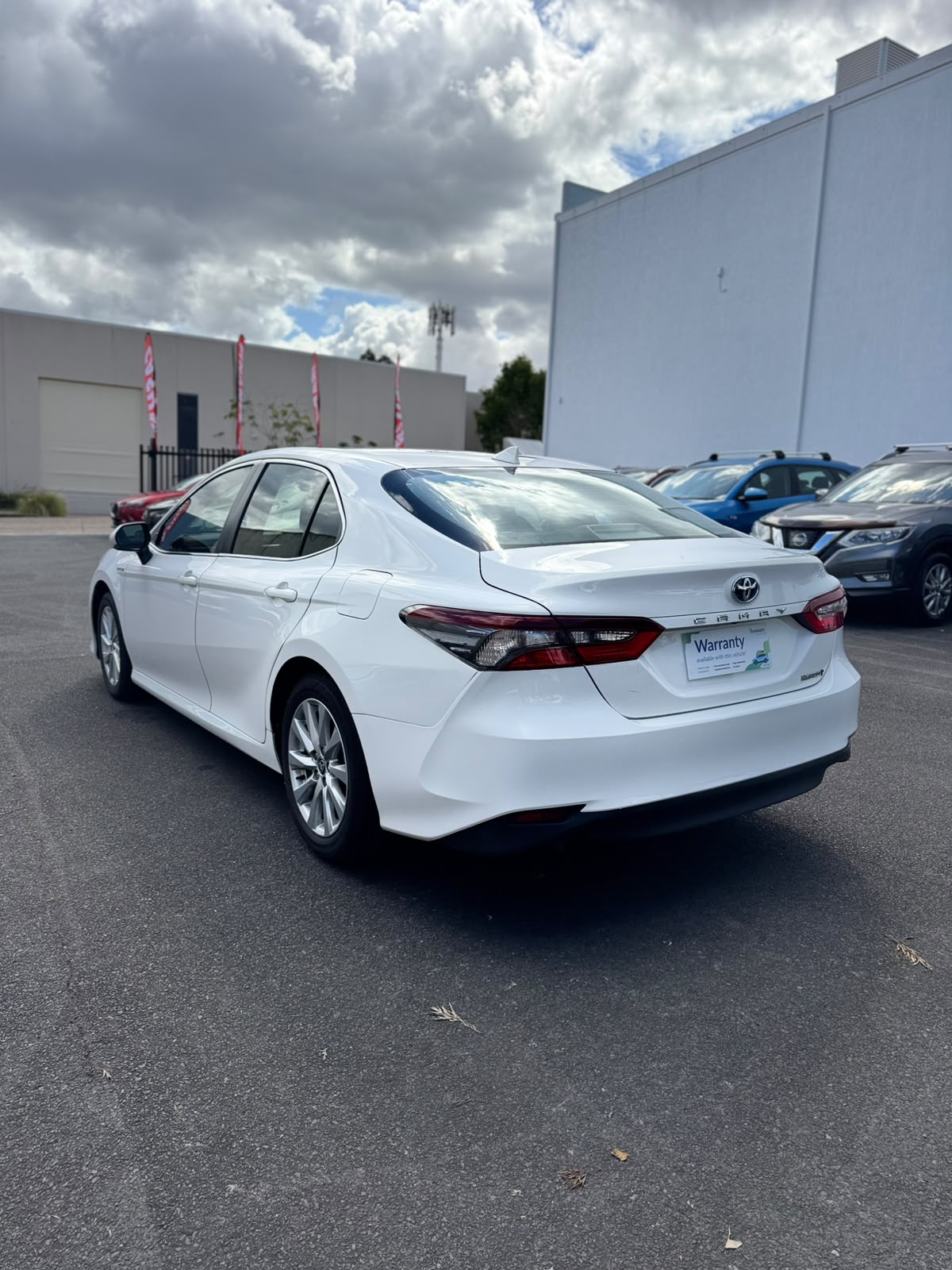 2021 Toyota Camry Hybrid Ascent Sedan in White.