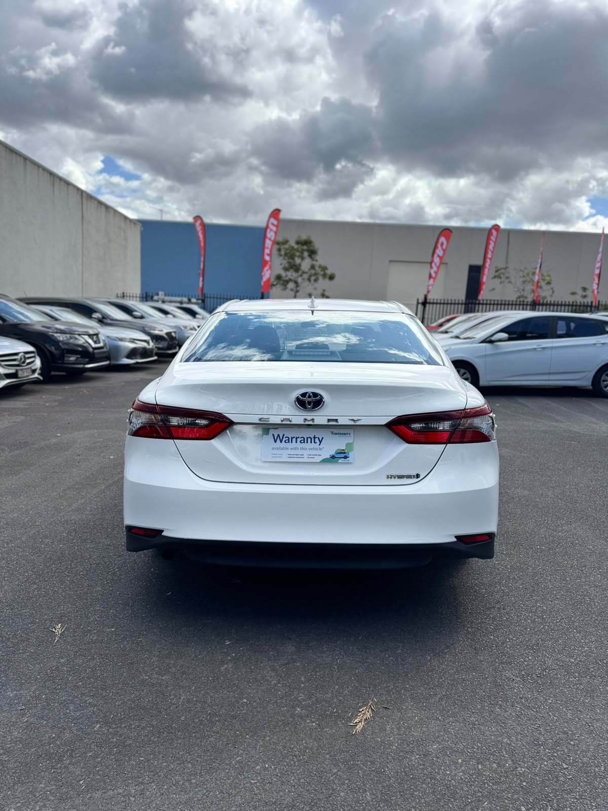 2021 Toyota Camry Hybrid Ascent Sedan in White.
